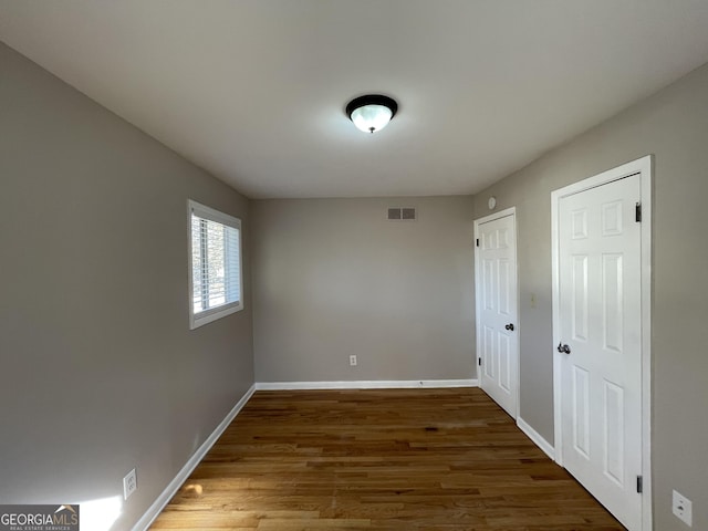 spare room featuring dark hardwood / wood-style floors