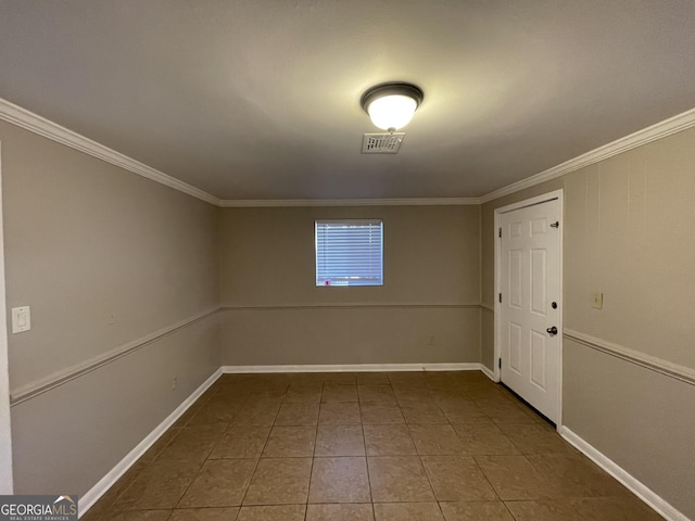 empty room with tile patterned flooring and ornamental molding