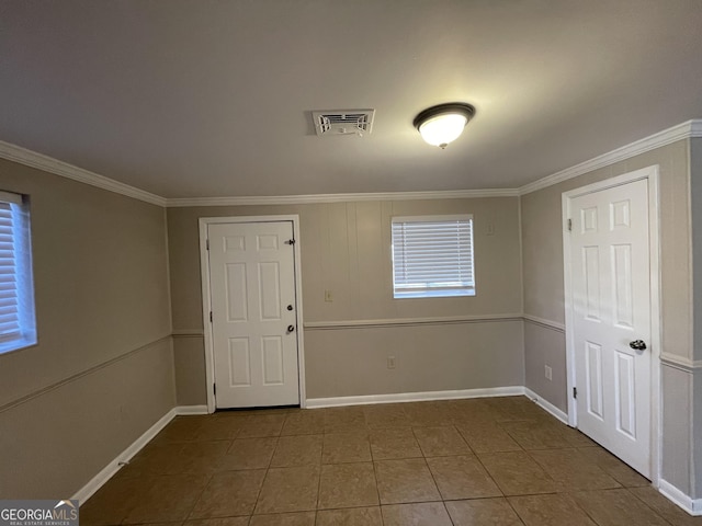 tiled empty room with crown molding