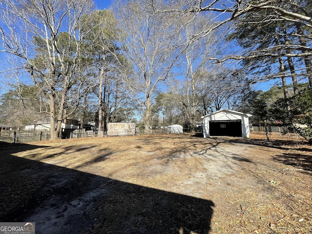 view of yard featuring an outbuilding and a garage