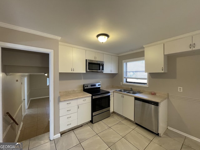 kitchen featuring light tile patterned floors, appliances with stainless steel finishes, sink, and white cabinets