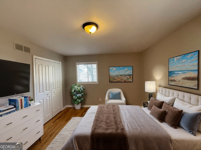 bedroom with hardwood / wood-style floors and a closet