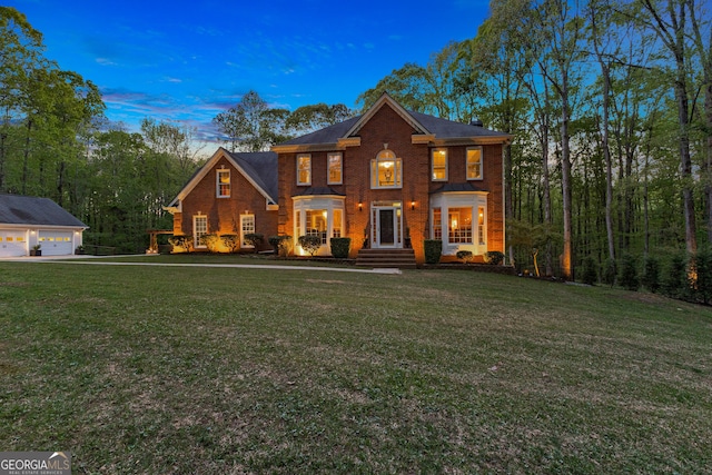 view of front of property with a yard and a garage