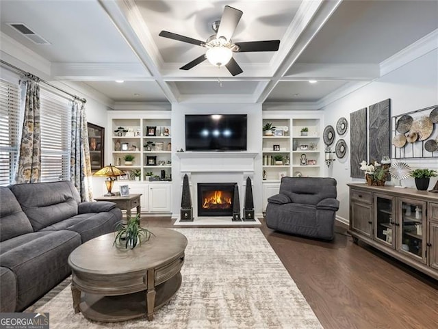 living room with beamed ceiling, coffered ceiling, built in features, and dark hardwood / wood-style floors