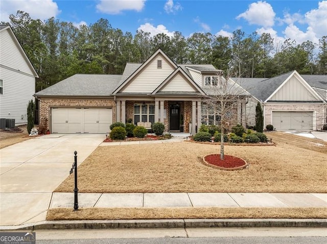 craftsman-style house with a garage and central AC unit