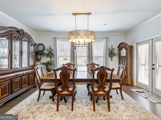 dining space featuring crown molding, plenty of natural light, and dark hardwood / wood-style flooring