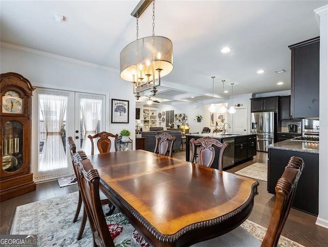 dining space featuring crown molding, sink, dark hardwood / wood-style flooring, and french doors