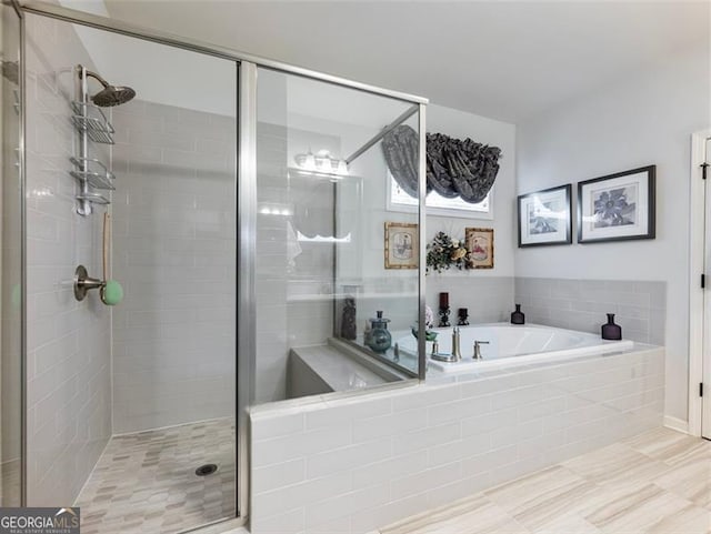 bathroom with shower with separate bathtub