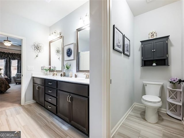 bathroom with vanity, ceiling fan, wood-type flooring, and toilet