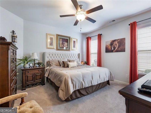 bedroom with light carpet and ceiling fan