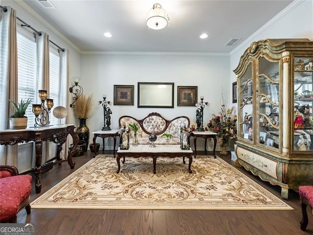 living area with dark hardwood / wood-style flooring and crown molding