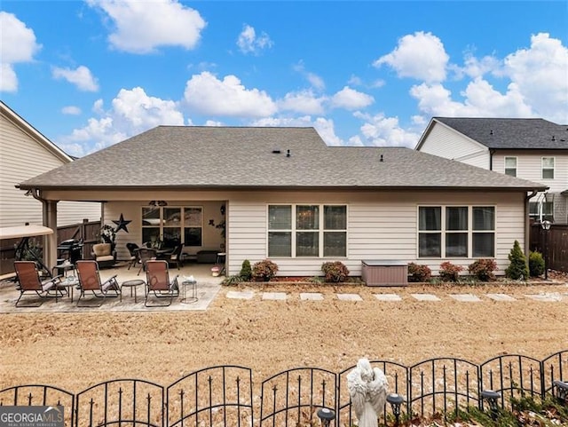 back of property with a patio