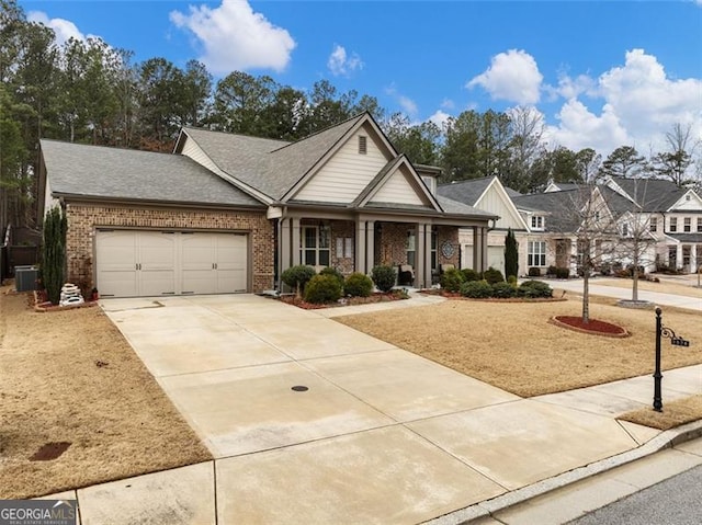 view of front of home featuring a garage and central AC