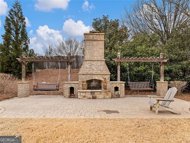 view of patio with an outdoor stone fireplace