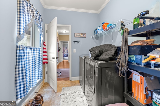 laundry area featuring crown molding, light tile patterned floors, and independent washer and dryer