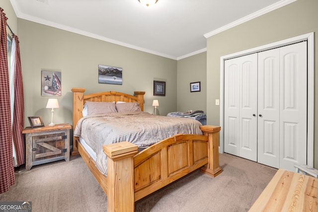 bedroom with ornamental molding, carpet floors, and a closet