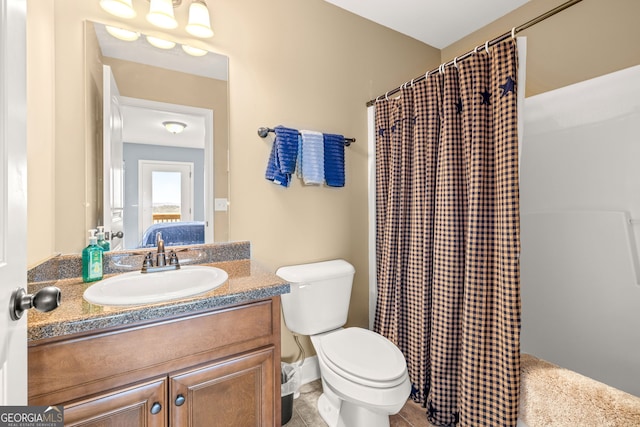 bathroom featuring vanity, curtained shower, tile patterned floors, and toilet