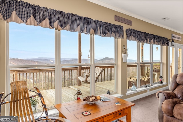 sunroom / solarium with a mountain view and plenty of natural light