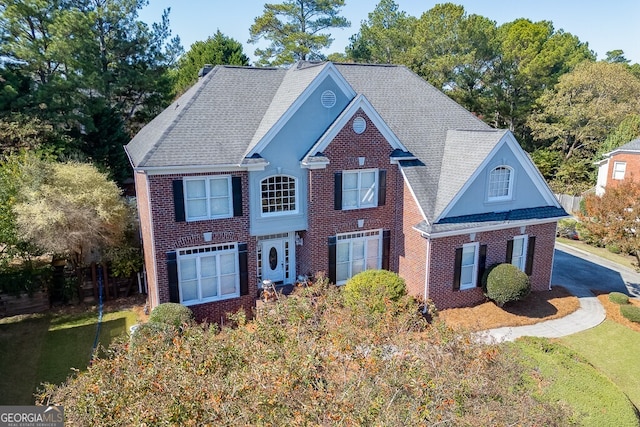 view of front of property with a garage and ac unit