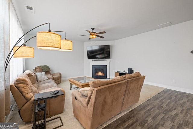 living room with ceiling fan, light hardwood / wood-style floors, and a healthy amount of sunlight