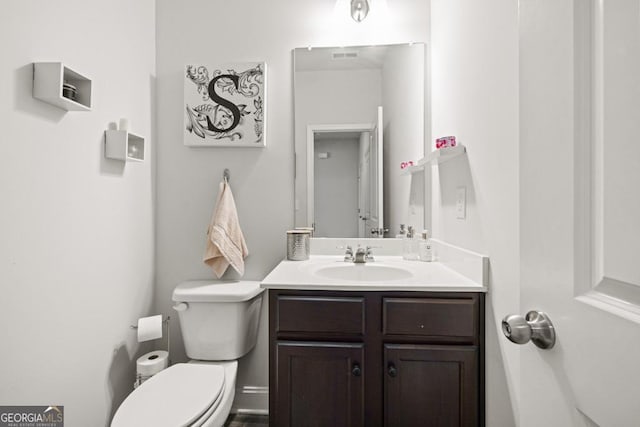 bathroom featuring vanity and toilet