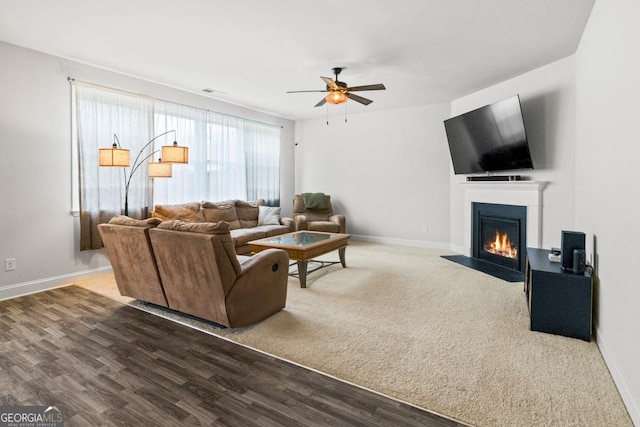 living room featuring hardwood / wood-style flooring and ceiling fan