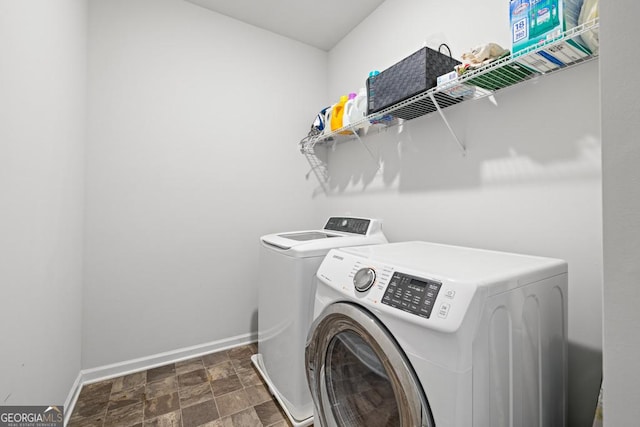 clothes washing area with washer and clothes dryer