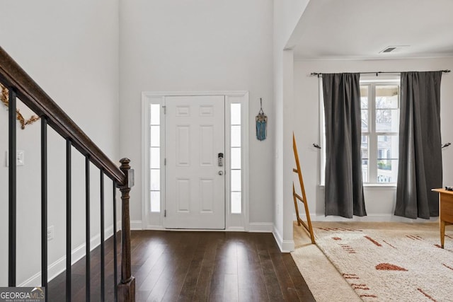 foyer with dark hardwood / wood-style floors and a wealth of natural light