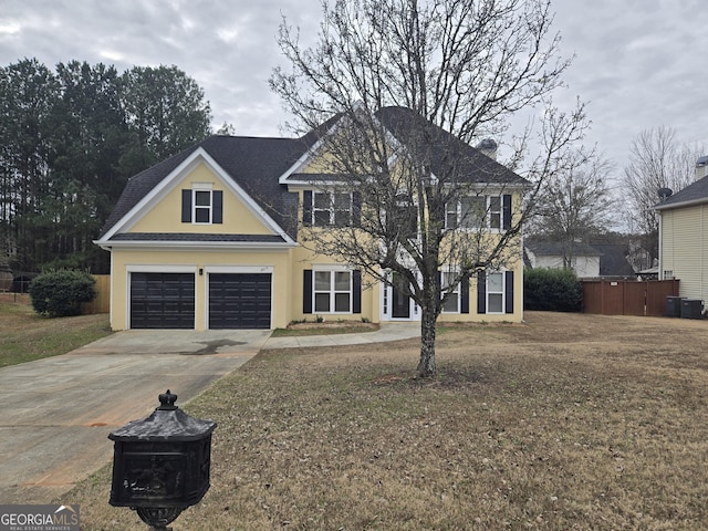 view of front of house with a garage and a front lawn