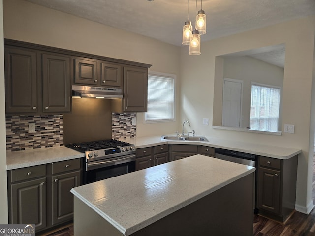 kitchen featuring sink, dark wood-type flooring, backsplash, a kitchen island, and stainless steel range with gas cooktop