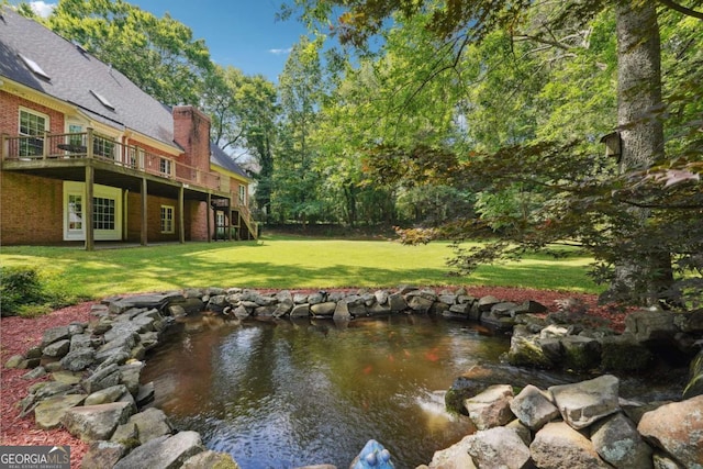 exterior space featuring a garden pond