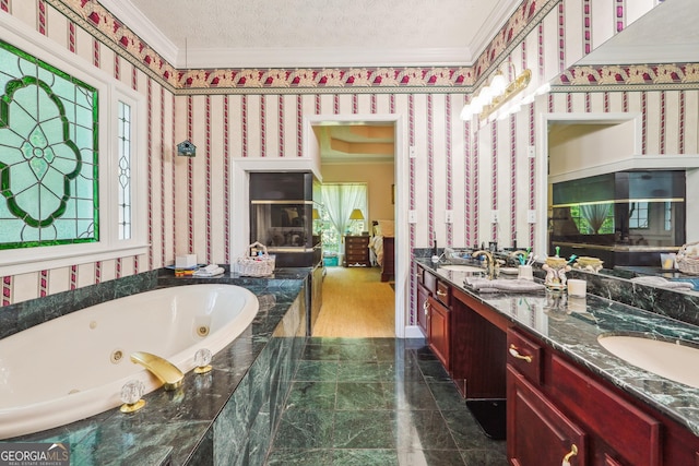 bathroom with tiled tub, crown molding, vanity, a wealth of natural light, and a textured ceiling