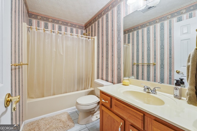 full bathroom featuring vanity, toilet, tile patterned floors, a textured ceiling, and shower / bath combo with shower curtain