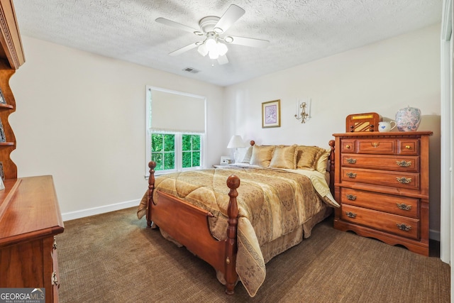 carpeted bedroom featuring ceiling fan and a textured ceiling