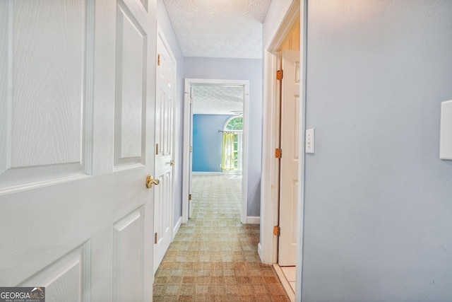 hallway featuring a textured ceiling