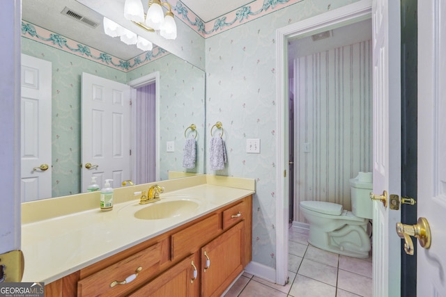 bathroom featuring vanity, toilet, and tile patterned flooring