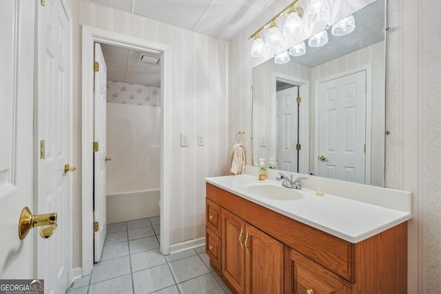 bathroom featuring tile patterned flooring, vanity, and tub / shower combination