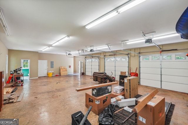 garage featuring a garage door opener and electric panel