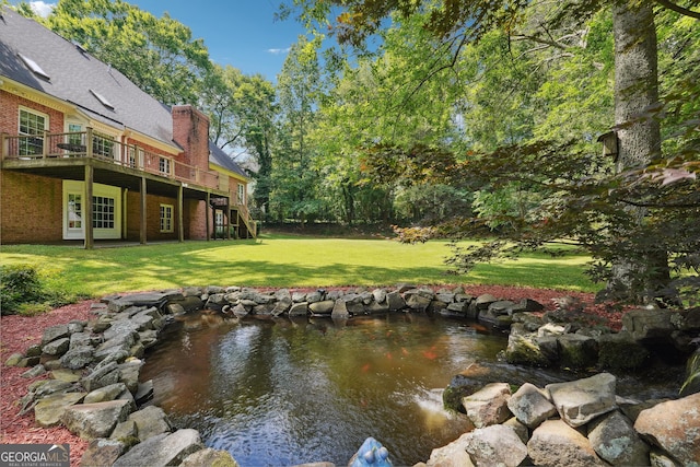 exterior space with a garden pond