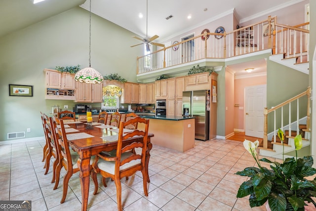 kitchen featuring crown molding, appliances with stainless steel finishes, and light brown cabinetry