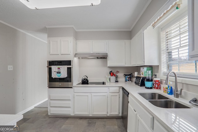 kitchen featuring a sink, oven, under cabinet range hood, white cabinetry, and black electric stovetop