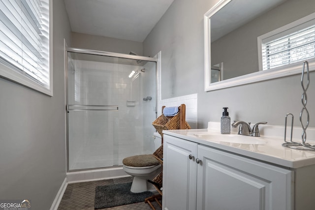 full bath with vanity, a shower stall, toilet, and tile patterned floors