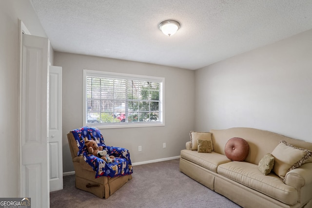 carpeted living room featuring a textured ceiling and baseboards