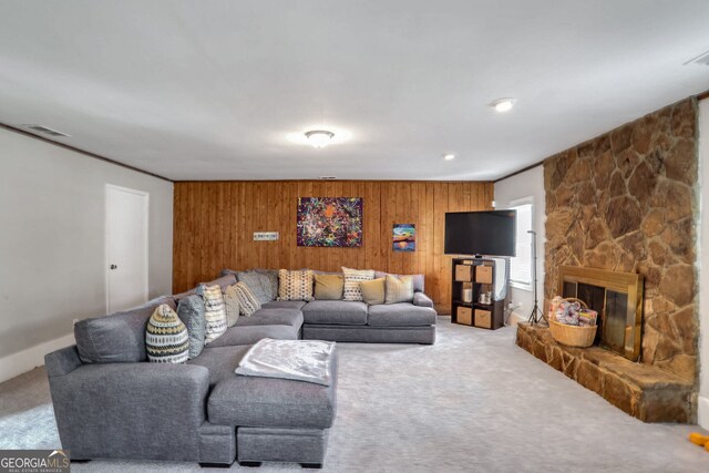 living room featuring crown molding, light carpet, and wood walls