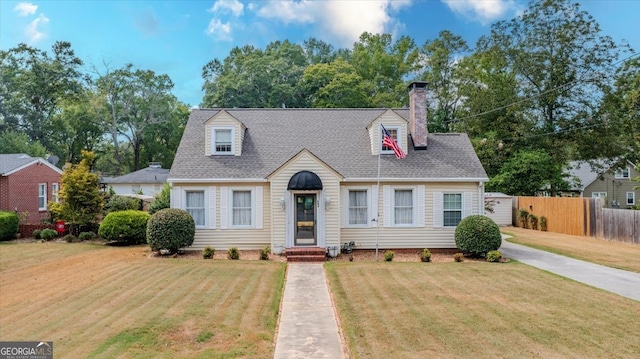 cape cod house featuring a front yard