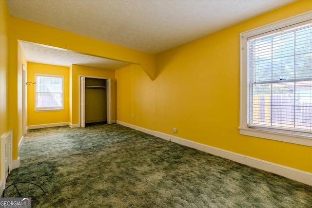 unfurnished bedroom with carpet floors, a closet, and a textured ceiling