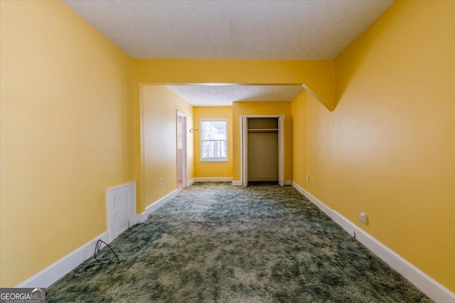 unfurnished bedroom featuring carpet floors and a textured ceiling