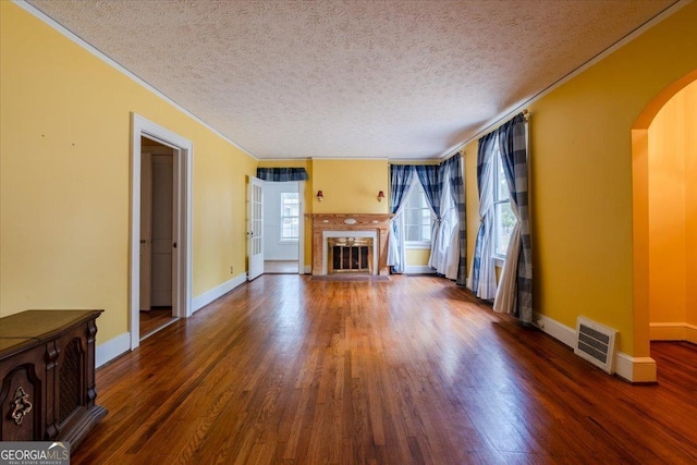 unfurnished living room with dark hardwood / wood-style flooring and a textured ceiling