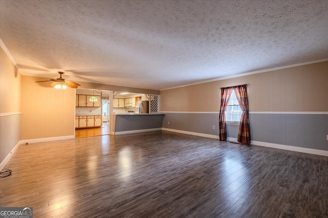 unfurnished living room featuring ceiling fan, ornamental molding, hardwood / wood-style floors, and a textured ceiling