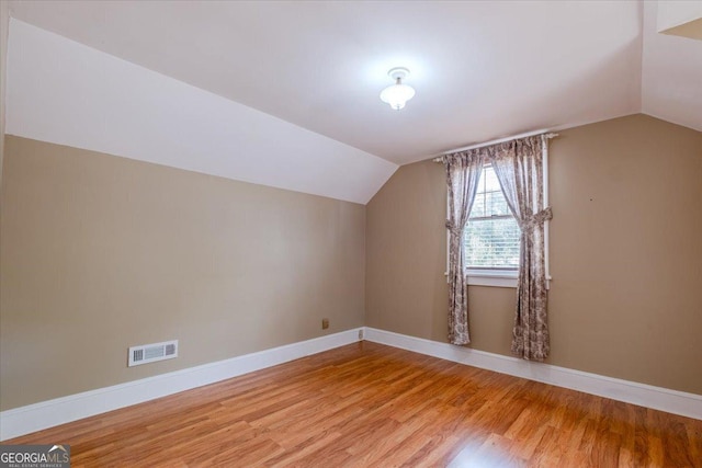 bonus room featuring vaulted ceiling and hardwood / wood-style floors